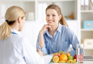 Young woman at nutritionist's office. Weight loss concept
