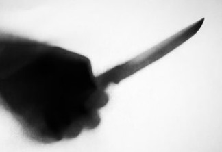 shadow of hand holding knife stabbing someone, soft focus, blurred