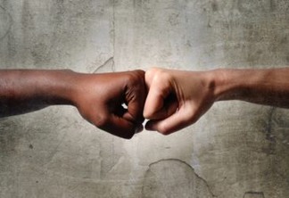 black African American race female hand touching knuckles with white Caucasian woman in agreement partnership and cooperation multiracial diversity immigration concept