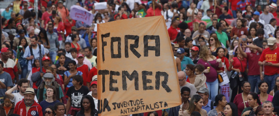 With a sign that reads in Portuguese "Temer out," demonstrators march against Brazil's acting President Michel Temer and in support of Brazil's suspended President Dilma Rousseff, in Sao Paulo, Brazil, Sunday, May 22, 2016. Temer took office after Rousseff was suspended for up to 180 days while the Senate holds an impeachment trial. (AP Photo/Andre Penner)