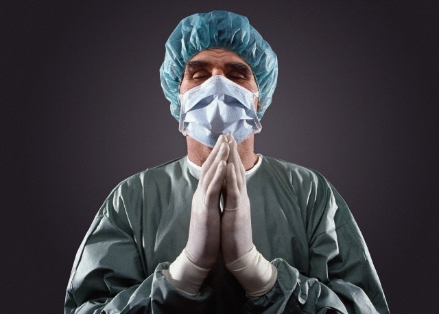 Portrait of a praying surgeon  --- Image by © Heide Benser/Corbis