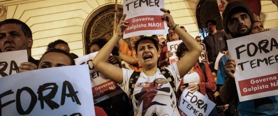 Supporters of Brazil's Dilma Rousseff demonstrate against new Brazilian President Michel Temer with signs reading "Temer out", after Rousseff was stripped of the country's presidency by a Senate impeachment vote in Rio de Janeiro, Brazil, on August 31, 2016. / AFP / YASUYOSHI CHIBA        (Photo credit should read YASUYOSHI CHIBA/AFP/Getty Images)