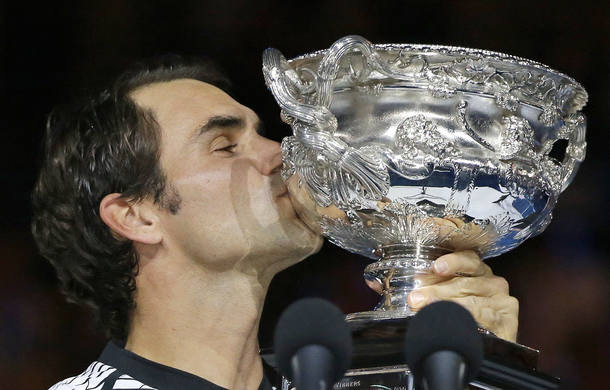 Switzerland's Roger Federer kisses his trophy after defeating Spain's Rafael Nadal in the men's singles final at the Australian Open tennis championships in Melbourne, Australia, Sunday, Jan. 29, 2017. (AP Photo/Aaron Favila)