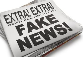 The front page of a newspaper with the headline "Fake News" which illustrates the current phenomena. Front section of newspaper is on top of loosely stacked remainder of newspaper. All visible text is authored by the photographer. Photographed in a studio setting on a white background with a slight wide angle lens.