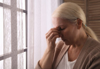Mature woman suffering from depression at home