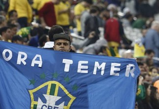A fan protests against Brazil's interim president Michel Temer during the Rio 2016 Olympic Games men's football quarterfinal match Brazil vs Colombia at the Corinthians Arena, in Sao Paulo, Brazil, on August 13, 2016. / AFP PHOTO / Miguel SCHINCARIOL