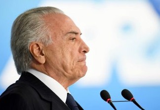 Brazilian President Michel Temer speaks during the signing ceremony of the decree that frees differential prices for payment in cash and with credit card at the Planalto Palace in Brasilia, on June 26, 2017. 
Temer faces his own crisis with the prosecutor general expected to request formal corruption charges against the president Monday or Tuesday. / AFP PHOTO / EVARISTO SA