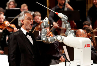 Humanoid robot YuMi conducts the Lucca Philharmonic Orchestra performing a concert alongside Italian tenor Andrea Bocelli at the Verdi Theatre in Pisa, Italy September 12, 2017. REUTERS/Remo Casilli     TPX IMAGES OF THE DAY - RC19496DD210