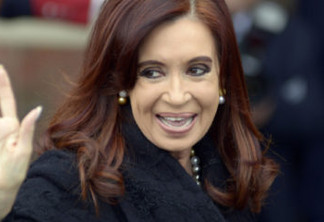 Argentina's President Cristina Fernandez waves to photographers as she arrives for the Mercosur trade bloc summit in Montevideo, Uruguay, Friday, July 12, 2013. Paraguay is expected to be readmitted into the bloc after member nations suspended its membership last year for having impeached and ousted President Fernando Lugo. (AP Photo/Matilde Campodonico)