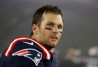FILE - In this Oct. 22, 2017, file photo, New England Patriots quarterback Tom Brady stands on the field after the team's NFL football game against the Atlanta Falcons in Foxborough, Mass. When Patriots owner Robert Kraft was asked earlier this year how long he thought Brady could continue to play quarterback in the NFL, Kraft said he could envision Brady playing into his 50s. It was a prediction that even Brady chuckled at after celebrating his 40th birthday in August. (AP Photo/Winslow Townson, File)