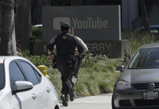 Officers run toward a YouTube office in San Bruno, Calif., Tuesday, April 3, 2018. Police say they’re responding to an active shooter at YouTube headquarters. (AP Photo/Jeff Chiu)