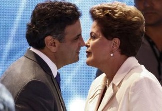 Presidential candidate for the Brazilian Workers' Party and current President Dilma Rousseff (R) greets Brazilian Social Democracy Party candidate Aecio Neves before a television debate in Sao Paulo, Brazil on July 26, 2014. Brazilian general elections will take place next October 5. AFP PHOTO / Miguel SCHINCARIOL