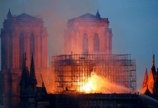PARIS, FRANCE - APRIL 15: Flames and smoke are seen billowing from the roof at Notre-Dame Cathedral on April 15, 2019 in Paris, France. A fire broke out on Monday afternoon and quickly spread across the building, collapsing the spire. The cause is yet unknown but officials said it was possibly linked to ongoing renovation work. (Photo by Chesnot/Getty Images)
