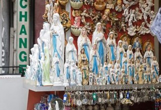 Lourdes, France - June 06, 2012: Statuettes of Our Lady exposed for sale in the souvenir storefront. There are many shops selling religious souvenirs, which have become extremely popular among pilgrims