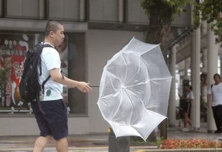 A man makes his way amid strong wind by typhoon Krosa in Miyazaki in this photo taken by Kyodo August 14, 2019. Mandatory credit Kyodo/via REUTERS Mandatory credit Kyodo/via REUTERS ATTENTION EDITORS - THIS IMAGE WAS PROVIDED BY A THIRD PARTY. MANDATORY CREDIT. JAPAN OUT.