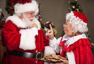 Ms. Claus scolding Santa Claus for eating too many cookies.