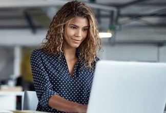 Cropped shot of a young businesswoman working on a laptop in a modern office