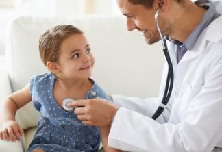 Shot of a handsome male doctor with an adorable young girl for a patient
